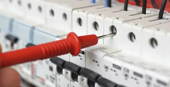 Electrical contractor testing circuit breakers during electrical repair in New Century, KS