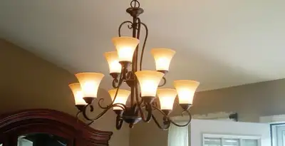 Classic ceiling chandelier installation with warm lighting in Olathe, KS