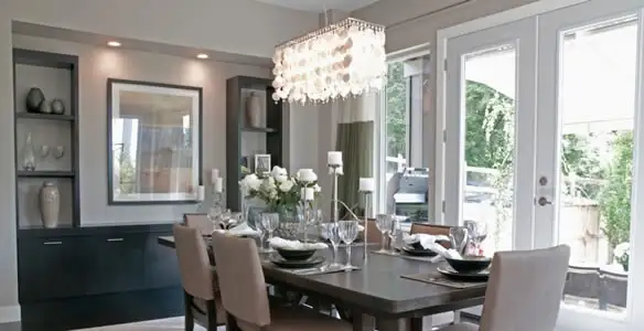 Elegant dining room chandelier installation above table in Olathe, KS