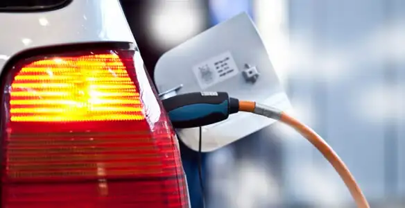 Electric car plugged into EV charger after professional installation in Olathe, KS