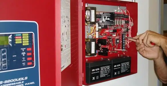 fire alarm installation service showing technician configuring fire alarm control panel in Olathe, KS