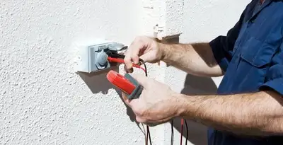 Electrician performing home electrical outlet and wiring inspection in Olathe, KS