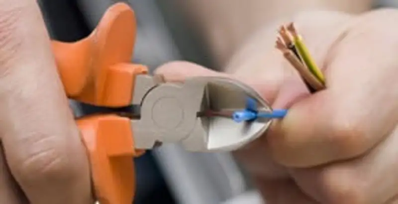 professional electrical services showing precise wire cutting by licensed electricians in Olathe, KS