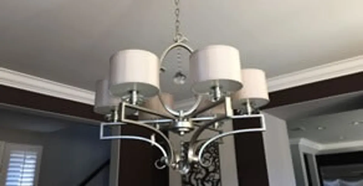 Modern chandelier installation with multiple light fixtures in Olathe, KS