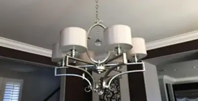 Modern chandelier installation with multiple light fixtures in Olathe, KS