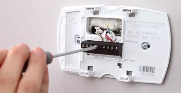 Thermostat installation service with proper wiring and secure wall mounting in Olathe, KS