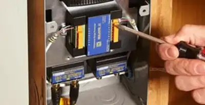 Whole home surge protection device being installed by a licensed electrician to protect electrical systems in Olathe, KS